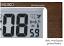 Dark, wood print dial facing on the Seiko QHR020BLH Digital Atomic Clock